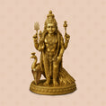 Gold-colored statue of a deity with a peacock on a beige background